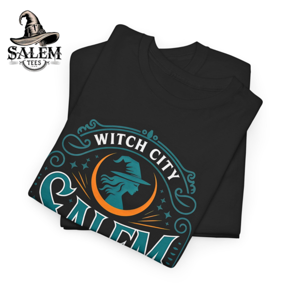 Salem Witch City t-shirt with teal gothic typography, witch silhouette moon design, and cauldron artwork